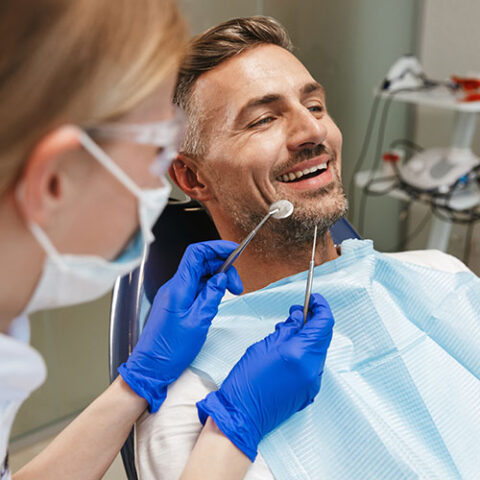 Thornhill dentist providing dental care to middle aged man in dentists chair